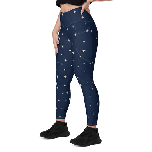 High-waisted navy leggings with twinkling star pattern and side pockets, fitted silhouette.