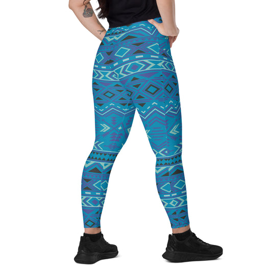 Teal geometric patterned high-waist leggings with side pockets, fitted and ankle-length.