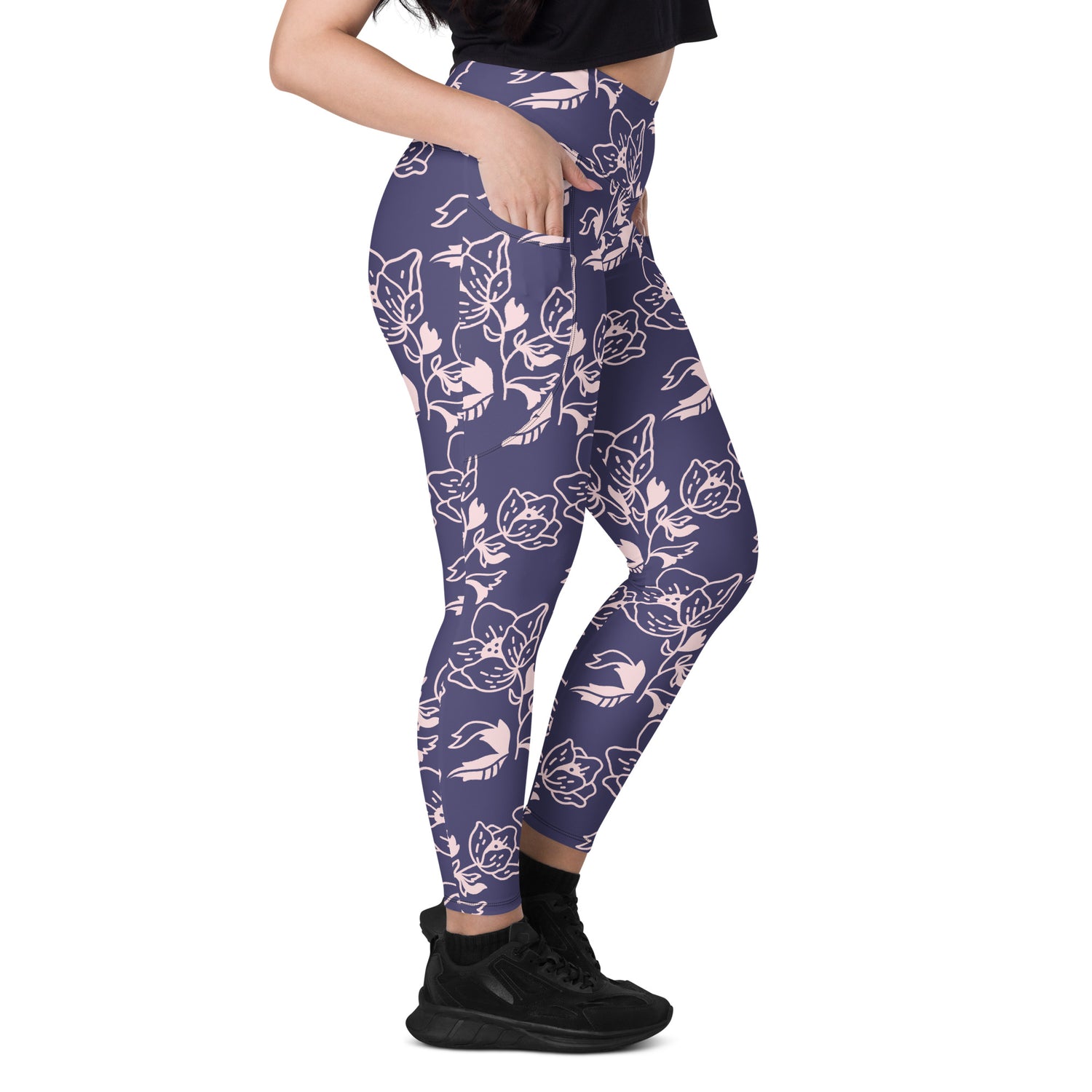 High-waist lavender leggings with white floral print and side pockets, worn with black sneakers.