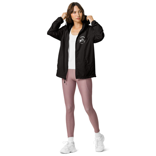 Black lightweight windbreaker with front zipper and logo on chest, worn over white top with mauve leggings and white sneakers.