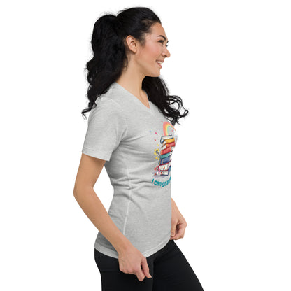Light grey unisex v-neck tee with colorful rainbow stack of books and "I Can Go Anywhere" text on front.