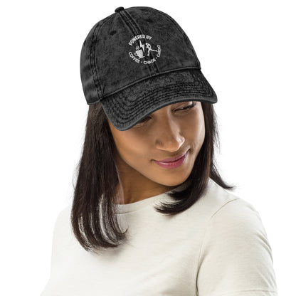 Black vintage cotton twill cap with white embroidered "Powered by Coffee, Chaos & Cardio" text and coffee cup graphic.