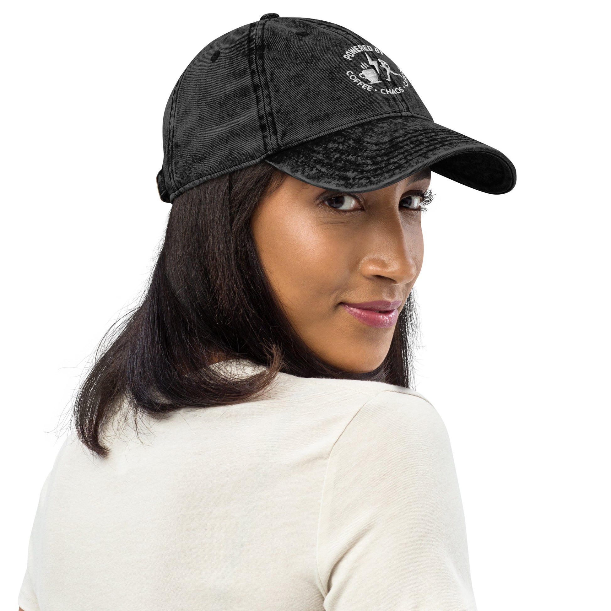 Black vintage cotton twill cap with white "Powered by Coffee, Chaos & Cardio" embroidered text and curved brim.