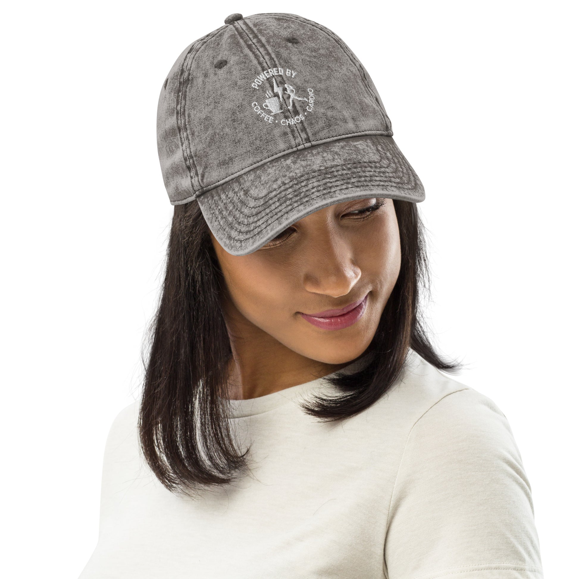 Charcoal grey vintage cotton twill cap with distressed finish and embroidered circular logo on front.