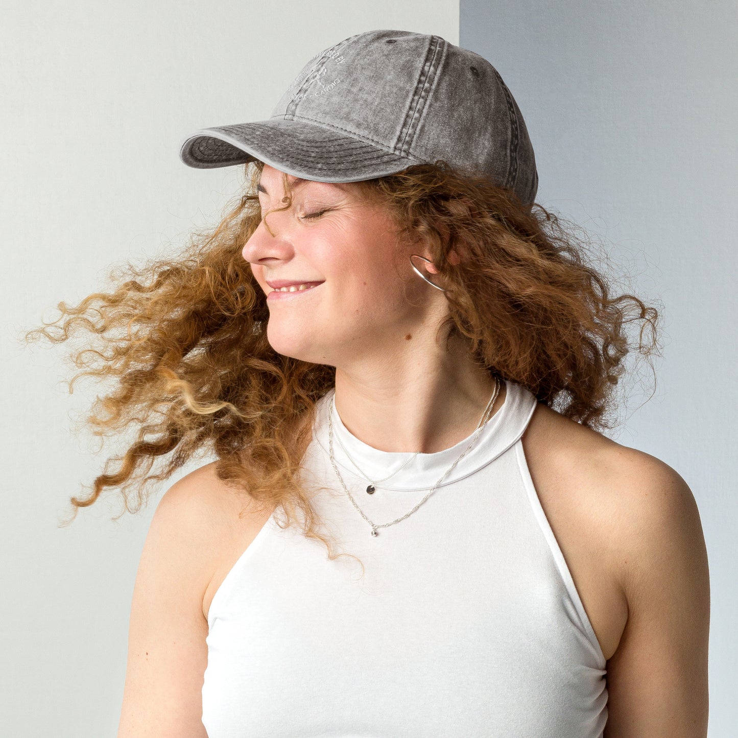 Charcoal grey vintage cotton twill cap with "Powered by Coffee, Chaos & Cardio" embroidered in white text.