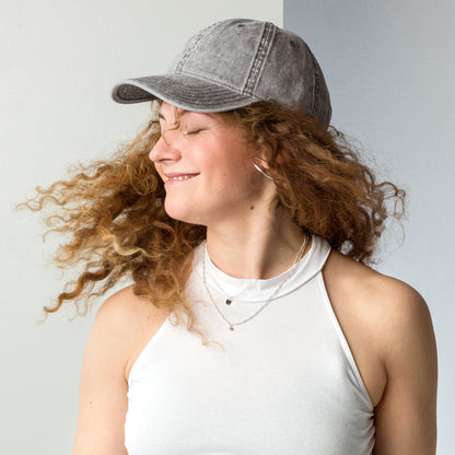 Charcoal grey vintage cotton twill cap with "Powered by Coffee, Chaos & Cardio" embroidered in white text.