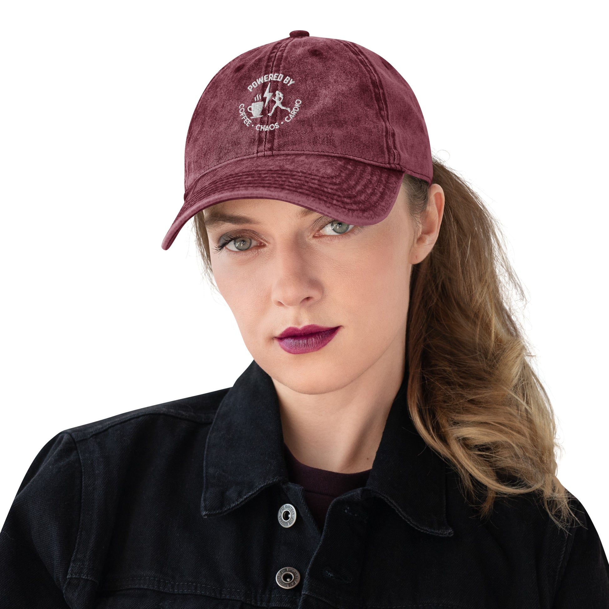Maroon vintage cotton twill cap with white embroidered "Powered by Coffee, Chaos & Cardio" text and graphic.