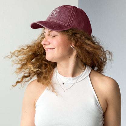 Maroon vintage cotton twill cap with curved brim and embroidered "Powered by Coffee, Chaos & Cardio" text worn by smiling.