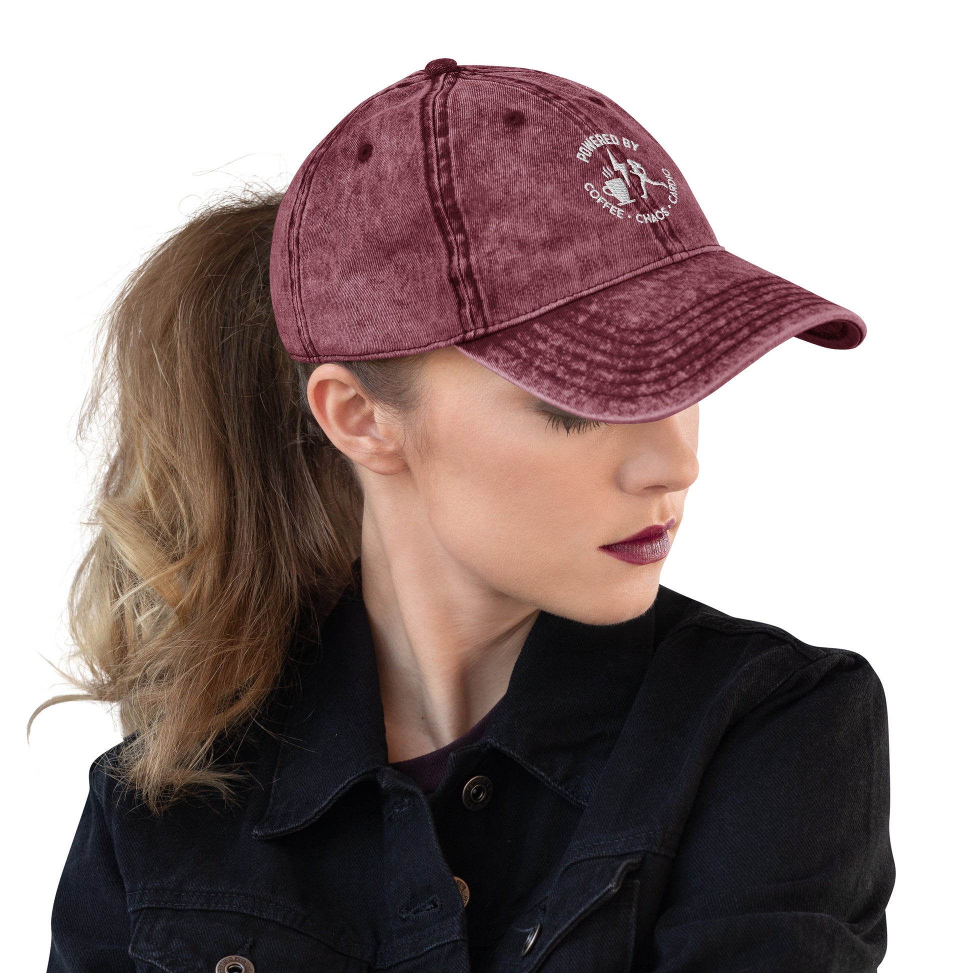 Maroon vintage cotton twill cap with white embroidered text and distressed finish worn with ponytail.