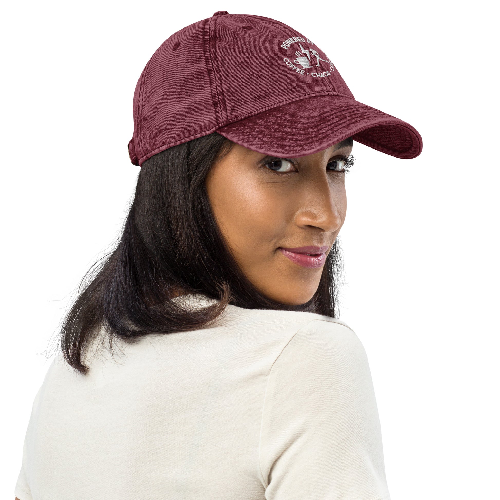 Maroon vintage cotton twill cap with white embroidered "Powered by Coffee, Chaos & Cardio" text and curved brim.
