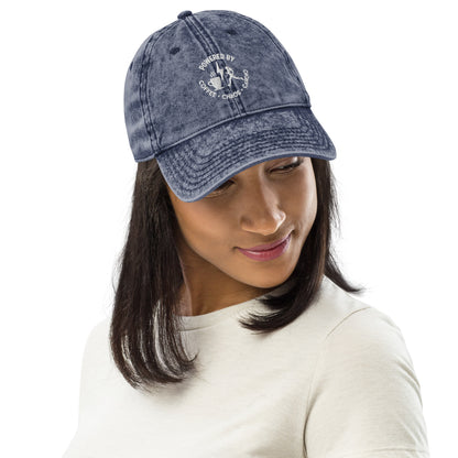 Navy vintage cotton twill cap with white embroidered "Powered by Coffee, Chaos & Cardio" text, curved brim.