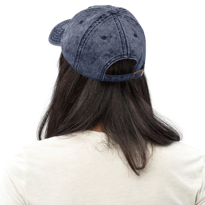Charcoal grey vintage cotton twill cap with adjustable strap shown from back on model with long dark hair.